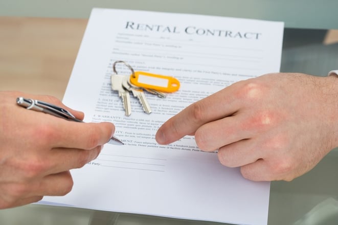 property manager having new tenants sign a rental agreement