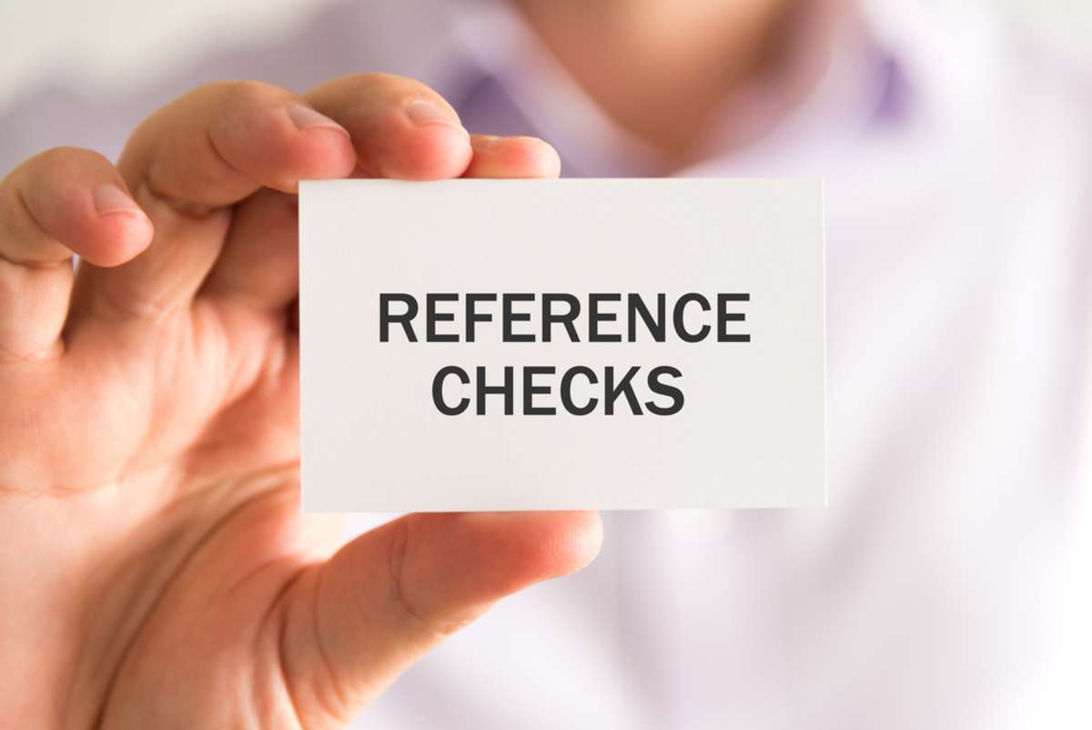 A person holding a card that says reference checks
