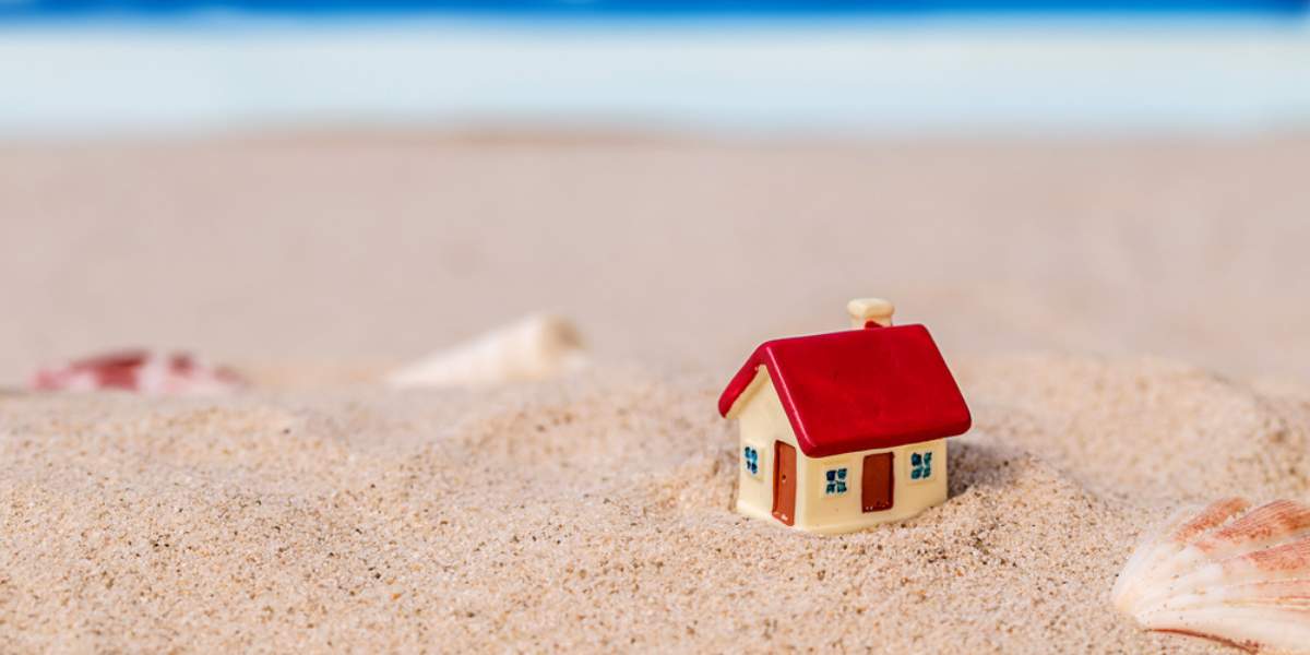 A mini house on the beach sand, property in the summer concept