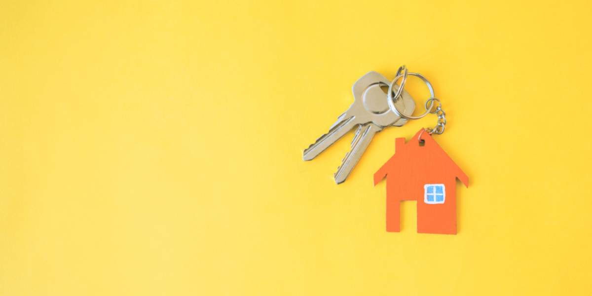 House and keys on a yellow background